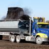 Chamness Technology Semi Truck and Side Dump Trailer being loaded with finished compost for delivery.